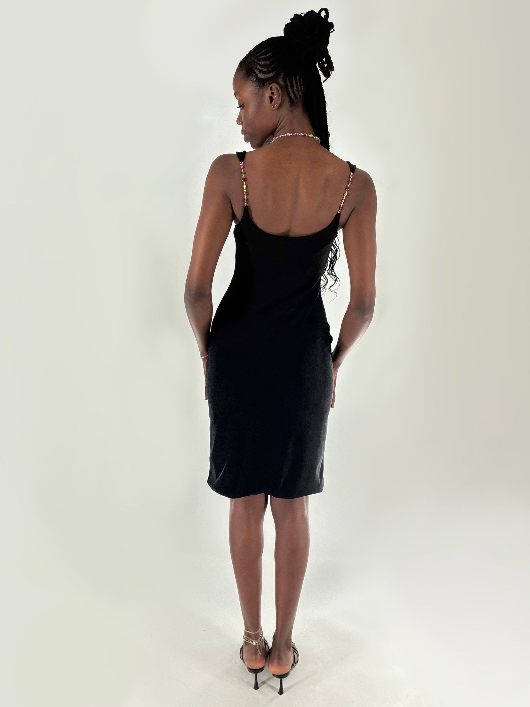 Back view of the black knit dress, showing the scoop back and beaded straps.